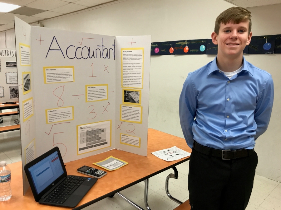 boy smiling in front of a tri board